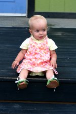 A happy baby wearing the Infant Flower Power Sandals